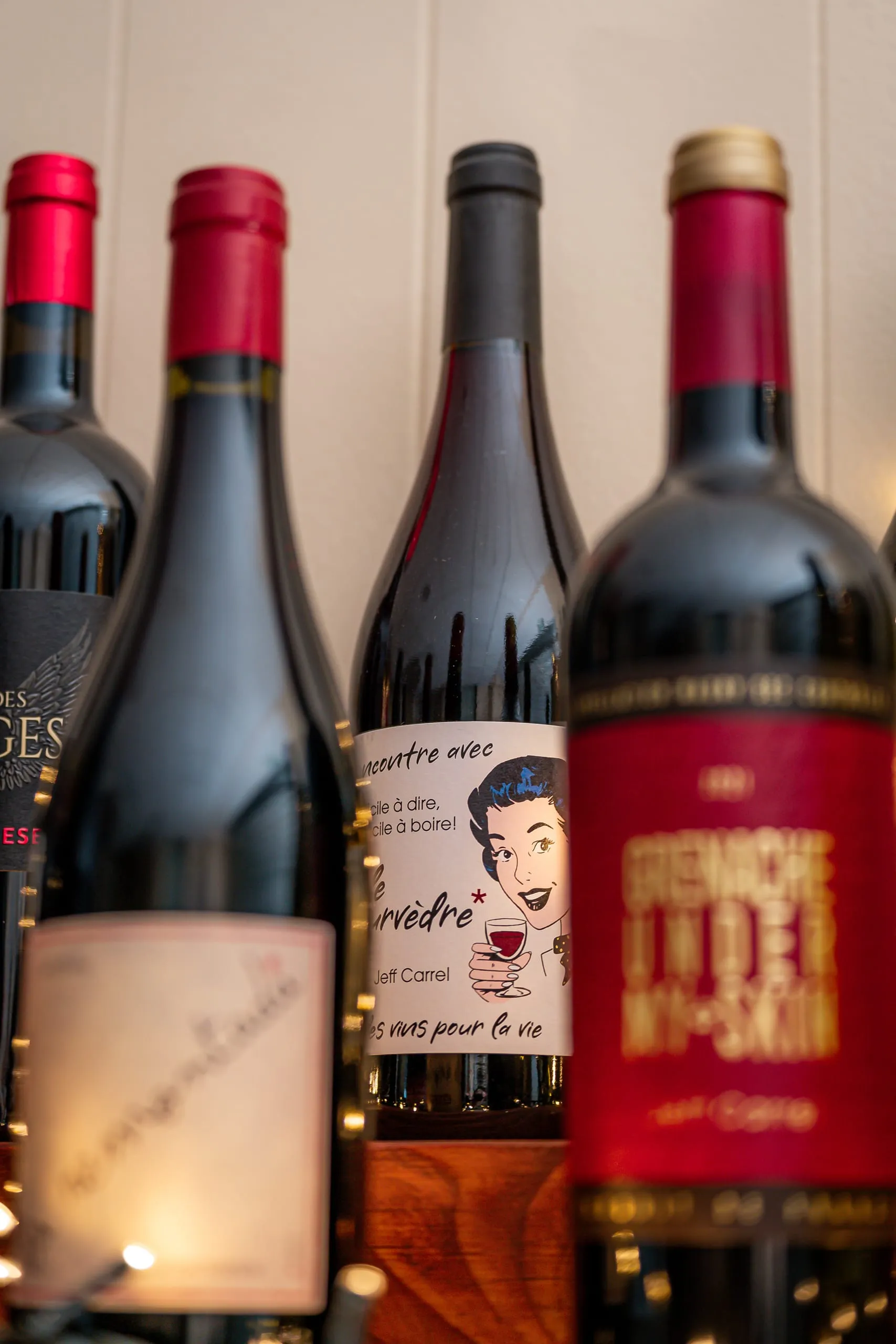 Bouteille de vin rouge Jeff Carrel entourée d’autres bouteilles